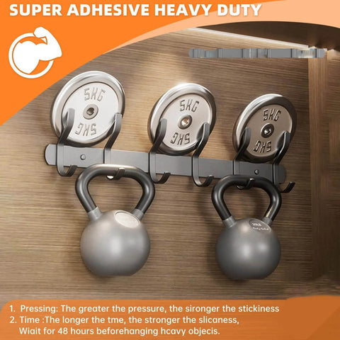 Image of heavy-duty double-sided wall tape holding kettlebells, showcasing grip strength on smooth surfaces for home or office decor.