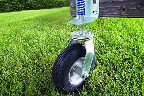 Heavy Duty Flat Free Spring Gate Caster With Universal Mount Eight Inch Wheel installed on wooden gate in grass