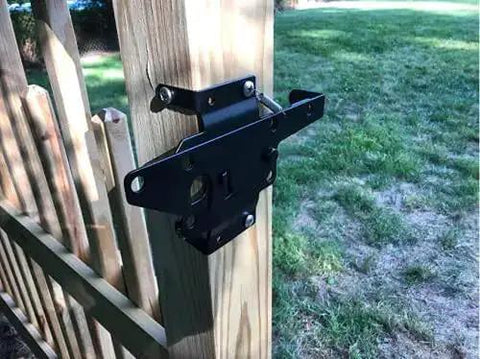 Beefy Heavy Duty Self Locking Gate Latch for wooden fence post mount, shown installed on a wooden fence, black finish.
