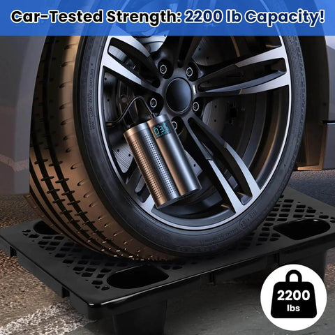 Car tire resting on Beefy Heavy Duty Interlocking Plastic Pallets With Breathable Grids For Storage In Garage Warehouse Supermarket Restaurant And Kitchen, 8 Pack, 23.6 x 15.7 x 4.7 In, Black, showing strength test