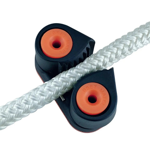 Close-up of Avejjbaey nylon rope clamp cleat; black housing with orange bearing inserts gripping a white braided rope.