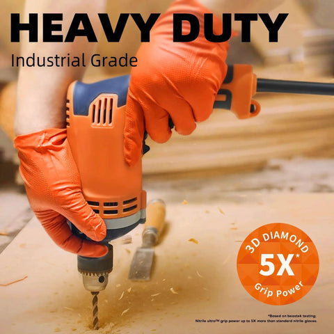 Close-up of orange-gloved hands using a drill, wearing 8 Mil Nitrile Powder Free Gloves Diamond Textured Heavy Duty Orange 100Pcs