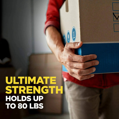 Person carrying a sealed box with Scotch Heavy Duty Packaging Tape 1.88 In x 54.6 yd Clear 3 In Core 6 Rolls For Strong Sealing and Shipping.