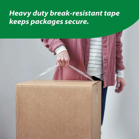 Person carrying box sealed with HD Clear Packing Tape Dispenser Heavy Duty Tape Gun for Boxes Shipping and Moving Includes One Refill Roll Foam Handle