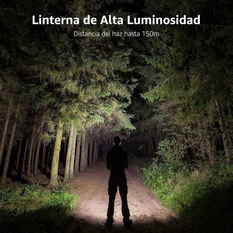 Person walking on forest path lit by powerful flashlight at night