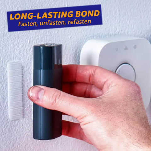 Close-up of Heavy Duty Adhesive Hook And Loop Tape Strips 16 Sets 1 By 3 Inch Double Sided Fasteners With Strong Back Adhesive being used on a wall.