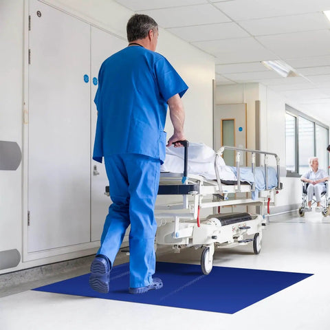 Hospital corridor with blue Heavy Duty Sticky Mat Tacky Adhesive Pads 300 Sheets Bulk Pack Includes 18x24 And 24x36 Inch Blue Mats