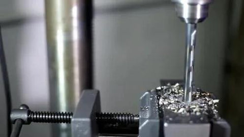 Close-up of KFD Series High Speed Steel Drill Bits Split Point One Eighth Inch drilling metal, showing precision and effectiveness.