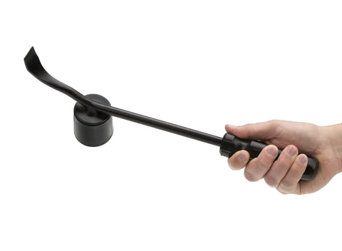 Heavy duty hubcap remover tool for auto mechanics with durable steel build, rubber hammer face, and wide pry blade held in hand.