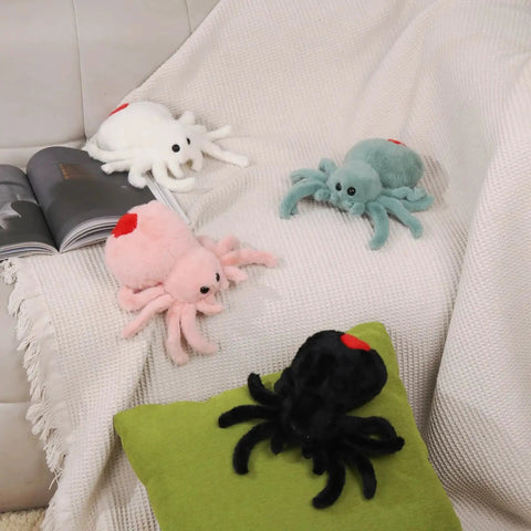 Super Soft Pink Spider Plush Toy For Kids And Adults with other plush spiders on blanket and pillow