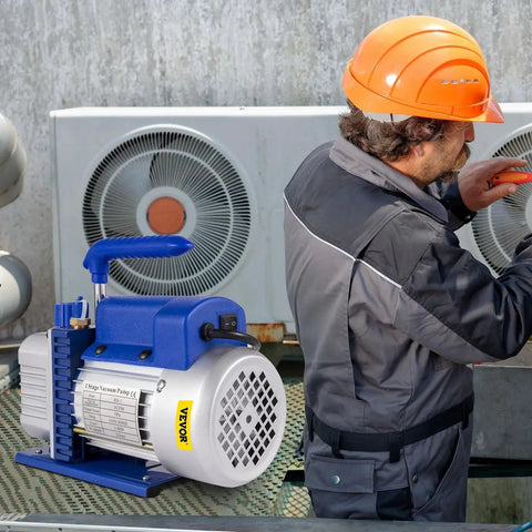 Technician using VEVOR 3CFM 1/4HP Single Stage Air Vacuum Pump Kit for HVAC maintenance
