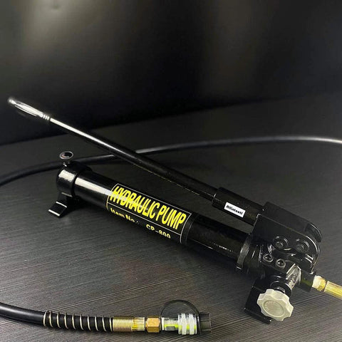 10000 psi Hydraulic Hand Pump 2 Speed Power Pack Hydraulic Lifting Pump with hose and metal body on dark surface