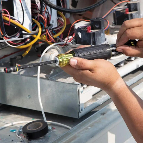Person using Flip Socket Kit for Impact Drivers 3-In-1 With 1/4 Inch And 5/16 Inch Hex Drivers, Klein Tools 32767 in mechanical setup