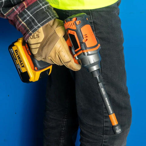 Worker using 9/16 inch Klein Tools 32930 SAE Magnetic Nut Setter on a power drill for heavy duty fastening.