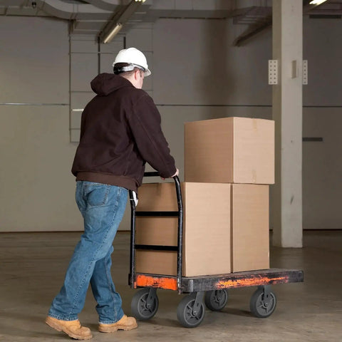 Worker pushing a cart with boxes using 8x2 Inch Heavy Duty Caster Wheels Set Of 4 Up To 3600 Pound Capacity Industrial Rubber Flat Tread Casters