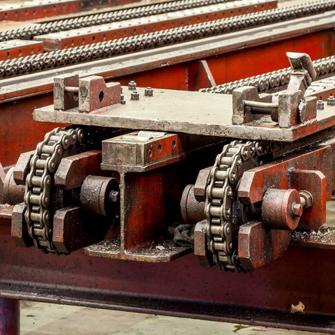 Industrial machinery featuring 15 Tooth Roller Sprocket B Type for No 25 Chain, One Quarter Inch Pitch installed in a drive system.