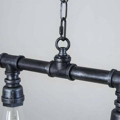 Close-up of Rustic Industrial Tube Pipe Chandelier With Five Light Edison Style Steampunk Pendant Light Fixture For Dining Room.