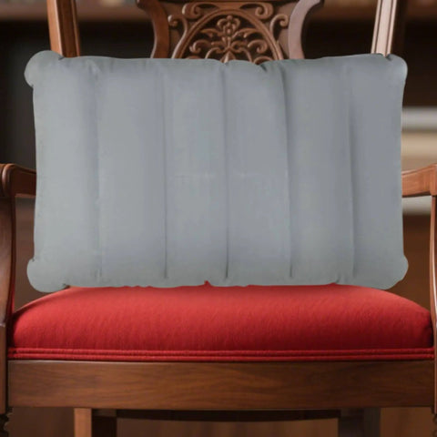 Gray inflatable seat cushion on wooden chair for travel and camping comfort, size 260x410 mm.