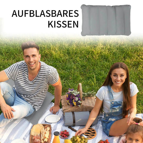 Inflatable seat cushion used for a picnic, with two people sitting on a blanket in a park. Cushion shown in top corner.
