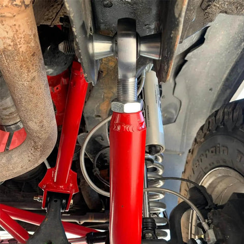 1.25 inch Heim joint rod end kit with tube adapters, misalignment spacers, installed in vehicle suspension system.