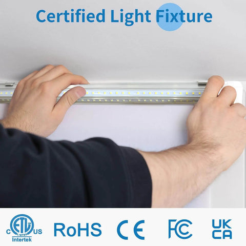 Hands installing Pack Of 4 Linkable LED Shop Lights For Garage And Basement 6 Foot Long 60W T8 Integrated Ceiling Light