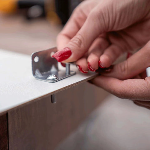 Close-up of hands installing bolt from 113 Piece Bolts Nuts And Washers Assortment Kit Galvanized Iron Hardware Set For Home Repair
