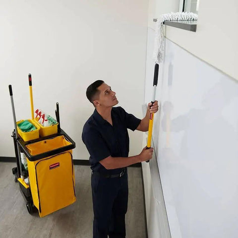 Janitor with cleaning cart, featuring Heavy Duty 24 Gallon Front Zippered Vinyl Replacement Bag For Industrial Janitorial Carts Yellow Waste Linen And Trash Collection Durable Front Loading Bag For Commercial Cleaning Compatible With Rubbermaid Commercial Carts, mopping window in office.