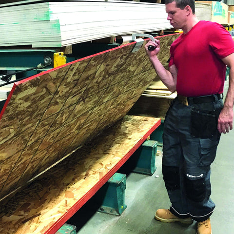 Man using ✝️ JawClaw Panel Gripper for Plywood, Drywall and Steel Sheets in workshop, ensuring smooth motion and alignment.