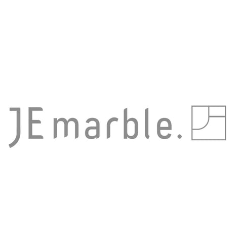 Logo of JE marble showcasing a modern design, featuring the brand name in a stylized font.
