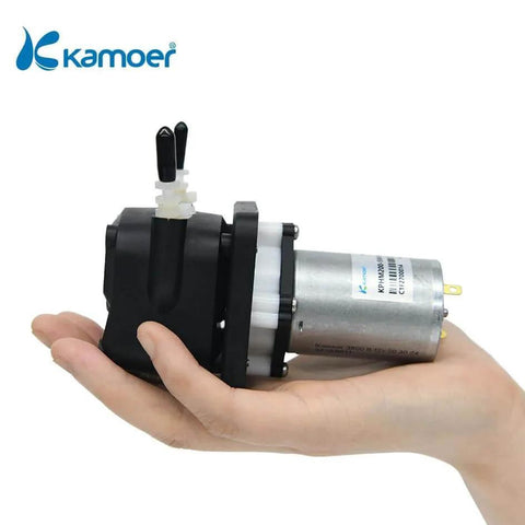 Person holding Kamoer KPHM200 small peristaltic pump 12V dc motor, showcasing compact size and design