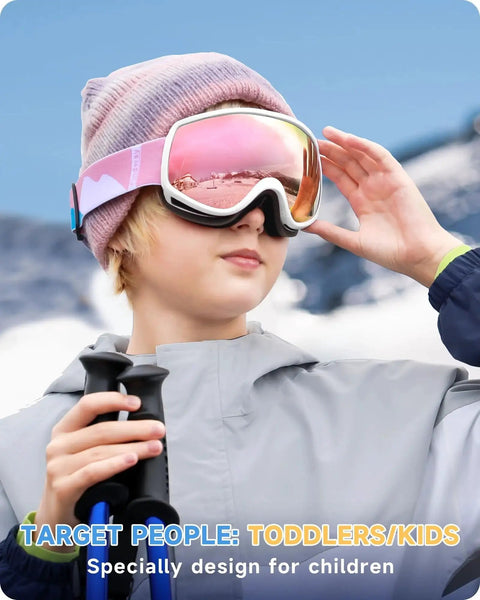 Child wearing Kids Ski Goggles For Boys And Girls 3 To 12 With Anti Fog UV400 Protection, pink frame, snowy background.
