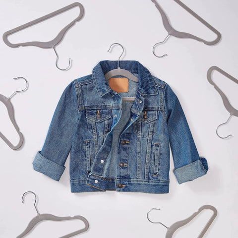 Ultra slim velvet kids hangers with non slip grip and shoulder notches displayed around denim kids jacket, perfect for compact nurseries.
