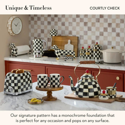 Kitchen countertop with checkered teapot, toaster, condiment jars, and cutting board in Mackenzie-Childs Courtly Check pattern.