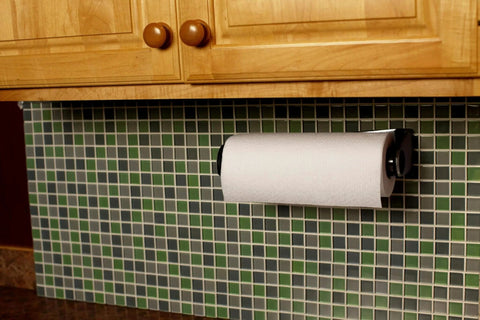 Paper towel roll mounted under kitchen cabinet on green tiled backsplash