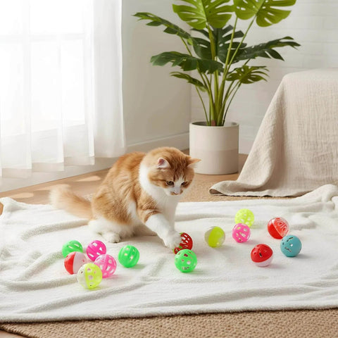 Kitten playing with 300 Pcs Cat Balls Bulk Plastic Lattice Balls Colorful Assorted Pack on a white blanket indoors.