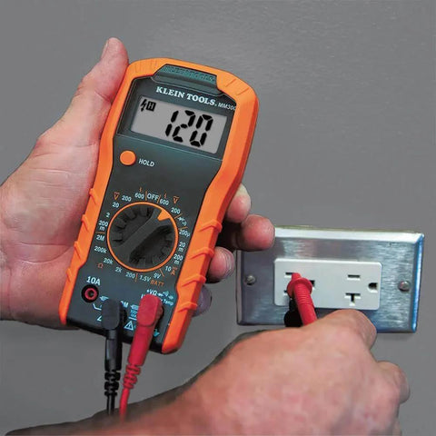 Hands using Electrical Test Kit with Digital Multimeter to measure voltage from an outlet, includes leads, 600V AC/DC capacity.