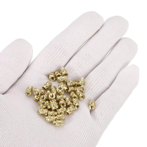Close-up of knurled insert nuts, 100pcs M3 x 7mm L x 5mm OD 3D printing brass nuts female threaded inserts on a gloved hand.
