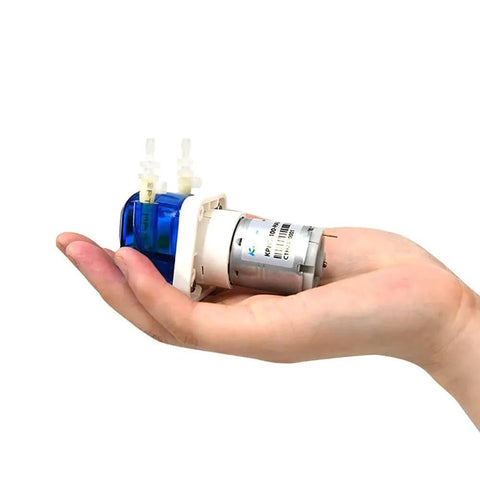KPHM100-HB low flow small peristaltic pump 12V dc motor held in hand for scale, showing compact size and high-precision dosing capability