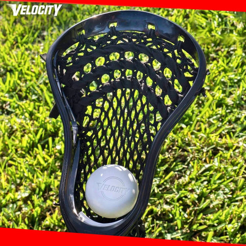 Lacrosse stick with white ball on grass, showcasing Practice Lacrosse Balls - 1, 2, 3, 6, 12, 18, 24, 36, 60 and 120 Packs - Official Size and Weight - Lime Green.