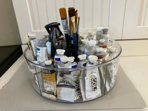 Rotating Makeup Organizer Turntable 11.5 Inch Large Cosmetic Storage with five dividers, filled with art supplies like paints and brushes.