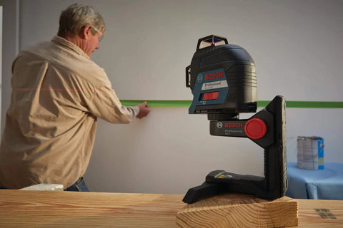 Clear room layout fast with a 360 degree three plane laser delivering bright alignment lines, long battery life via VISIMAX tech, and includes batteries, target, pouch, and heavy duty case for jobsite reliability. Laser level on stand projecting line in room.