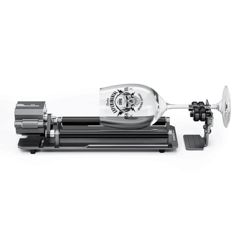 4 In 1 Laser Rotary Chuck Roller With Risers holding a glass for engraving, ideal for cylindrical objects like rings and mugs.