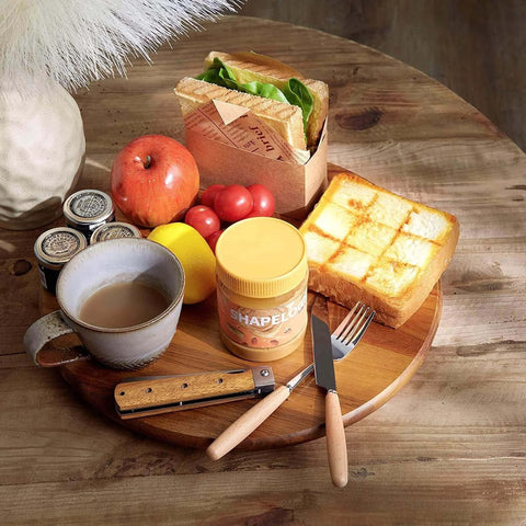 16 inch acacia wood lazy susan cabinet organizer displaying breakfast items on a wooden table.