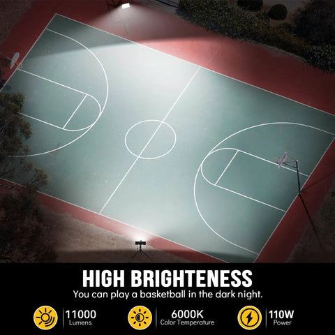 Aerial view of a brightly lit basketball court at night highlighting the illumination from two LED floodlights on the court edges.