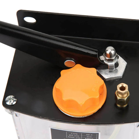 Close-up of left hand operated manual lubrication pump for CNC machine tools, showing handle and oil cap.