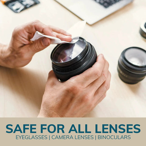 Person using Individually Wrapped Lens Cleaning Wipes 210 Count For Eyeglasses And Sunglasses on camera lens on desk