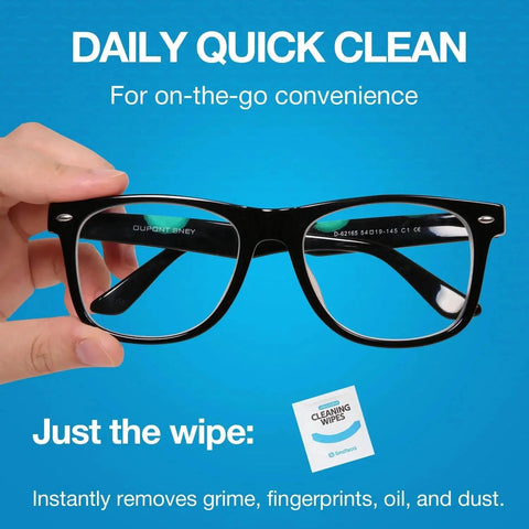 Hand holding eyeglasses with a cleaning wipe package, demonstrating the Lens Wipes And Microfiber Cloths Value Kit For Eyeglasses And Screens.