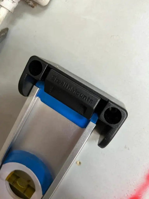 Close-up of a Universal Level Holder 4 Pack With Locking Level Mounts Fits All Brands Easy To Install Anywhere Pro Grade Build Made In The UK StealthMounts Compatible Accessory For Quick Leveling On Every Job Site