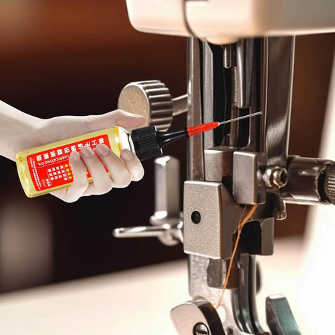 Hand applying Extend Door Lock Hinge Lubricant 60ml Grease And Penetrating Oil to sewing machine for smooth operation