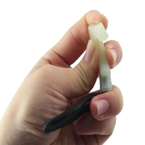 Close-up of a 8 Piece Luminous Tail Cord Zip Puller Set For Outdoor Backpacks 42x44mm Heavy Duty TPU Extender in hand, showing T-shape and nylon rope.